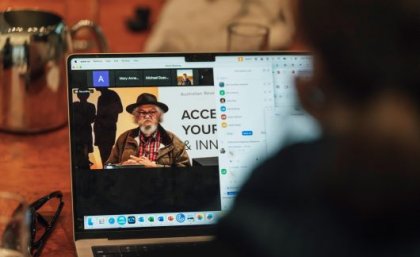 Image: ARDC Symposium, June 2024. An image showing a laptop screen over a person's shoulder, with an Indigenous Australian on the screen.